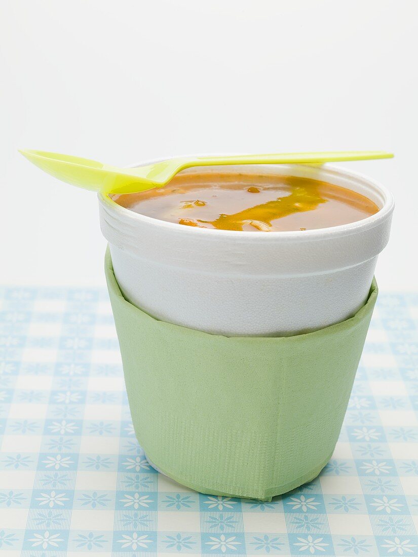 Tomato and vegetable soup in polystyrene cup