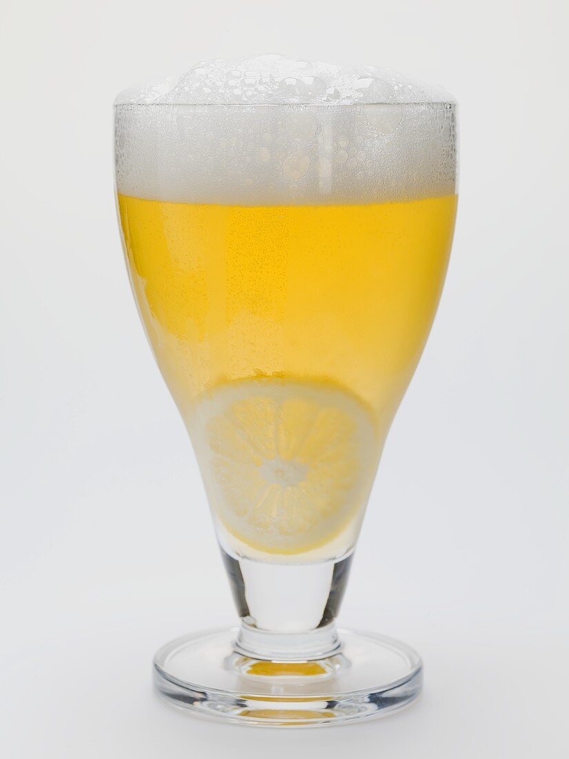Glass of shandy with slice of lemon (UK)