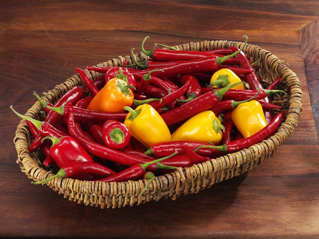 Fresh chillies and small peppers in basket