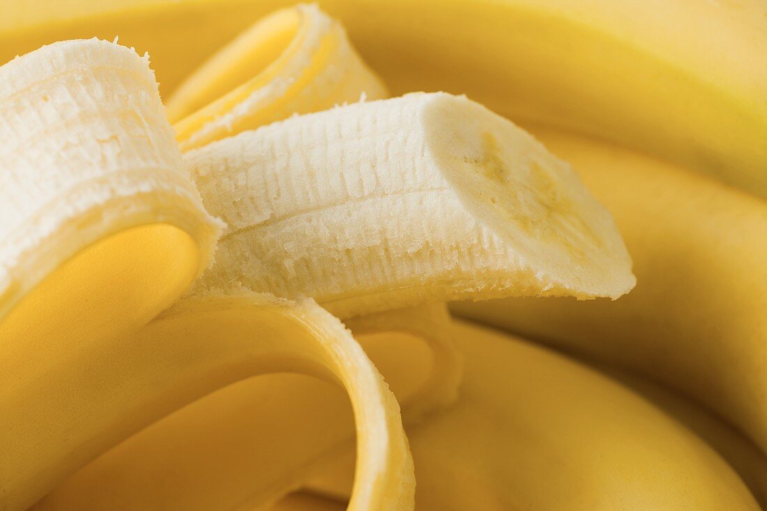 Fresh bananas, one half-peeled (close-up)