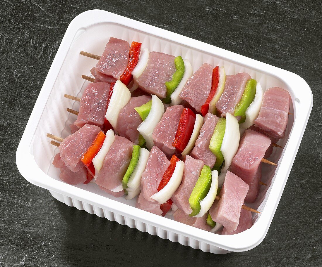 Meat kebabs in plastic container