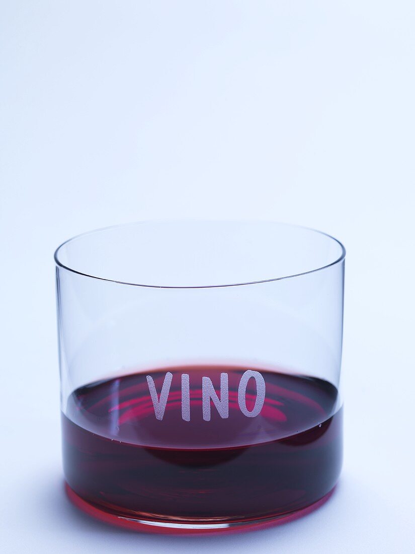 Glass of red wine with the word VINO