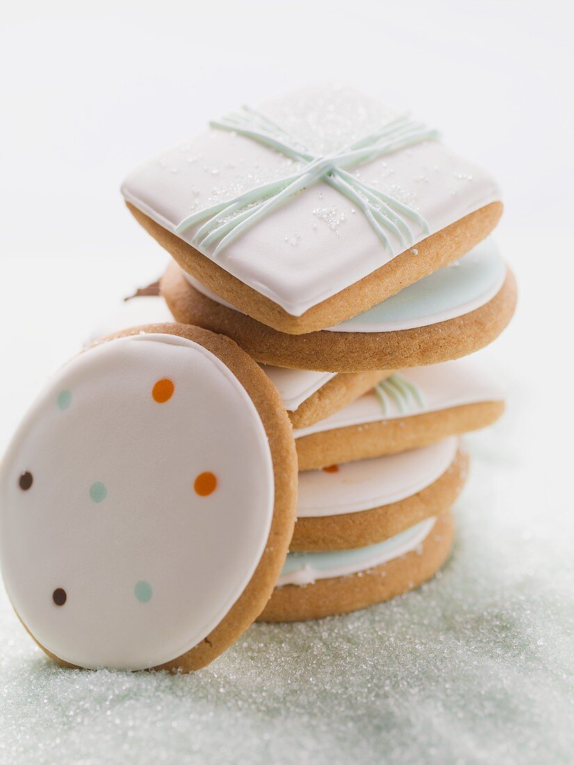 Assorted iced biscuits on blue sugar