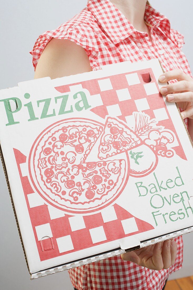 Woman holding pizza box