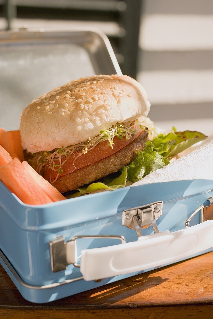 Burger and vegetables in lunch box