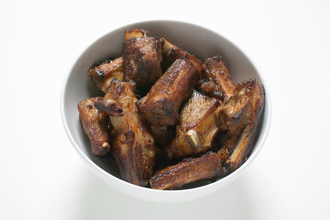 Roasted pork ribs in white bowl