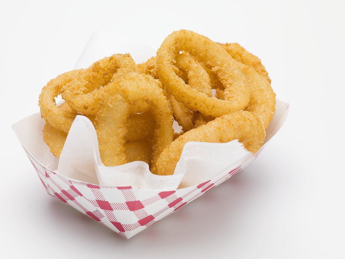 Deep-fried onion rings in paper dish