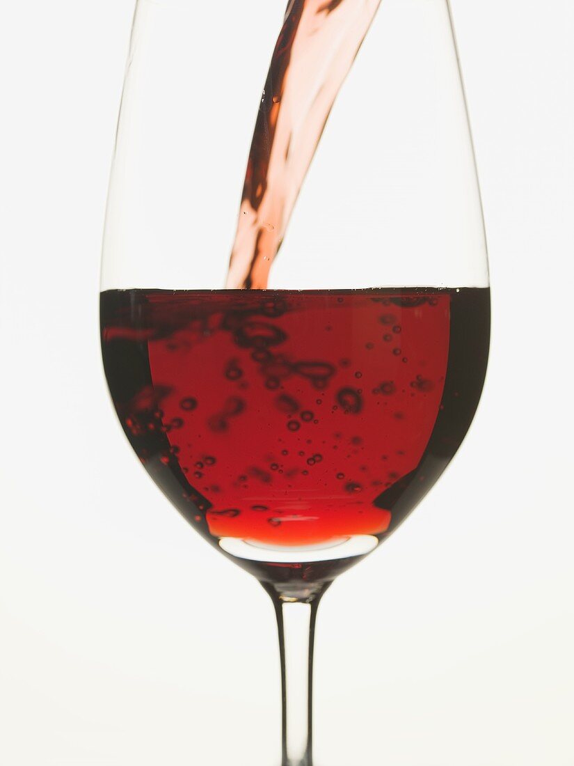 Pouring red wine into a glass