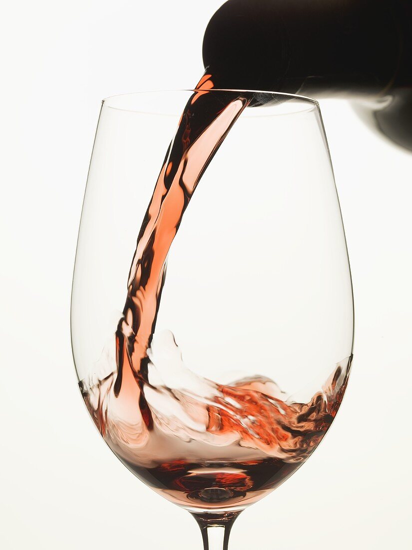 Pouring red wine into a glass