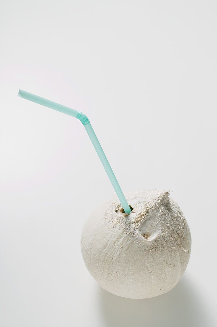 Shelled coconut with straw