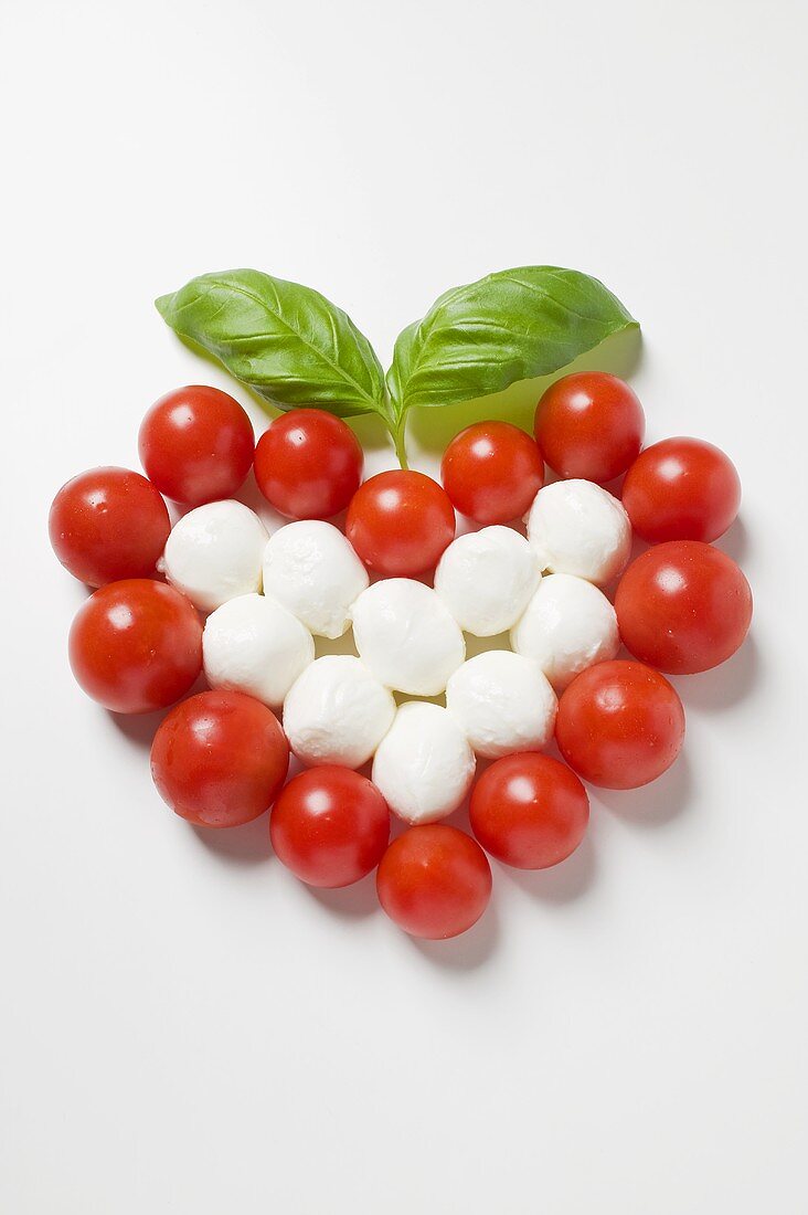 Tomato and mozzarella forming a heart with basil