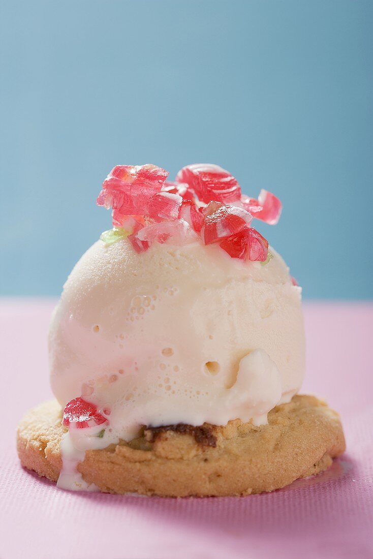 Scoop of ice cream with peppermints on cookie