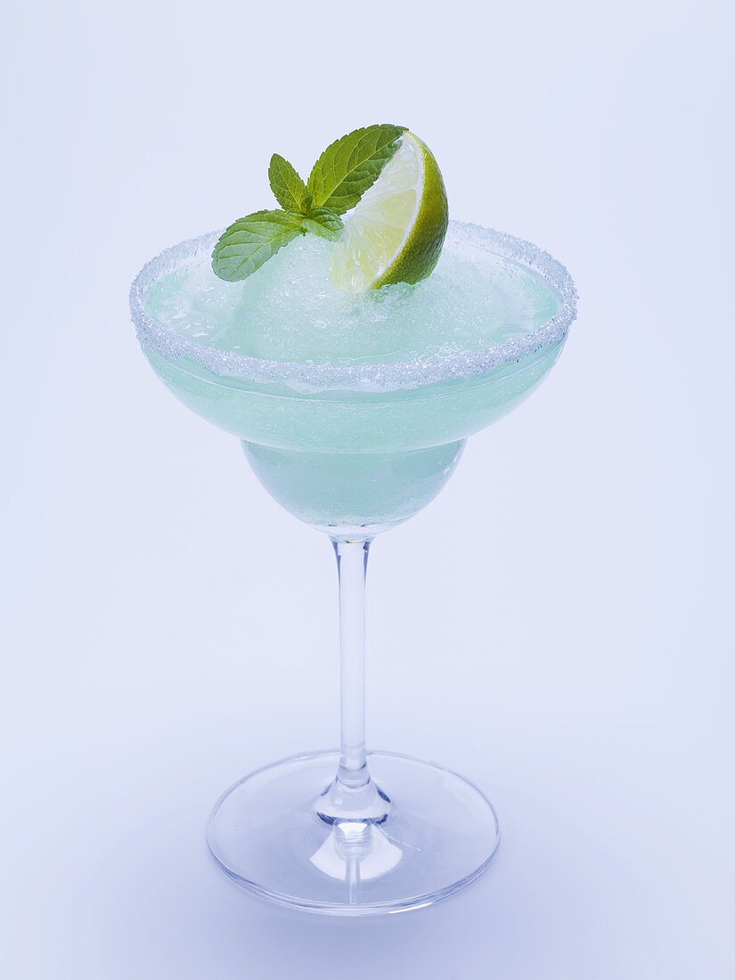 Frozen Margarita with lime wedge and mint