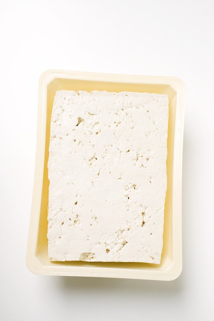 Tofu in plastic container (overhead view)