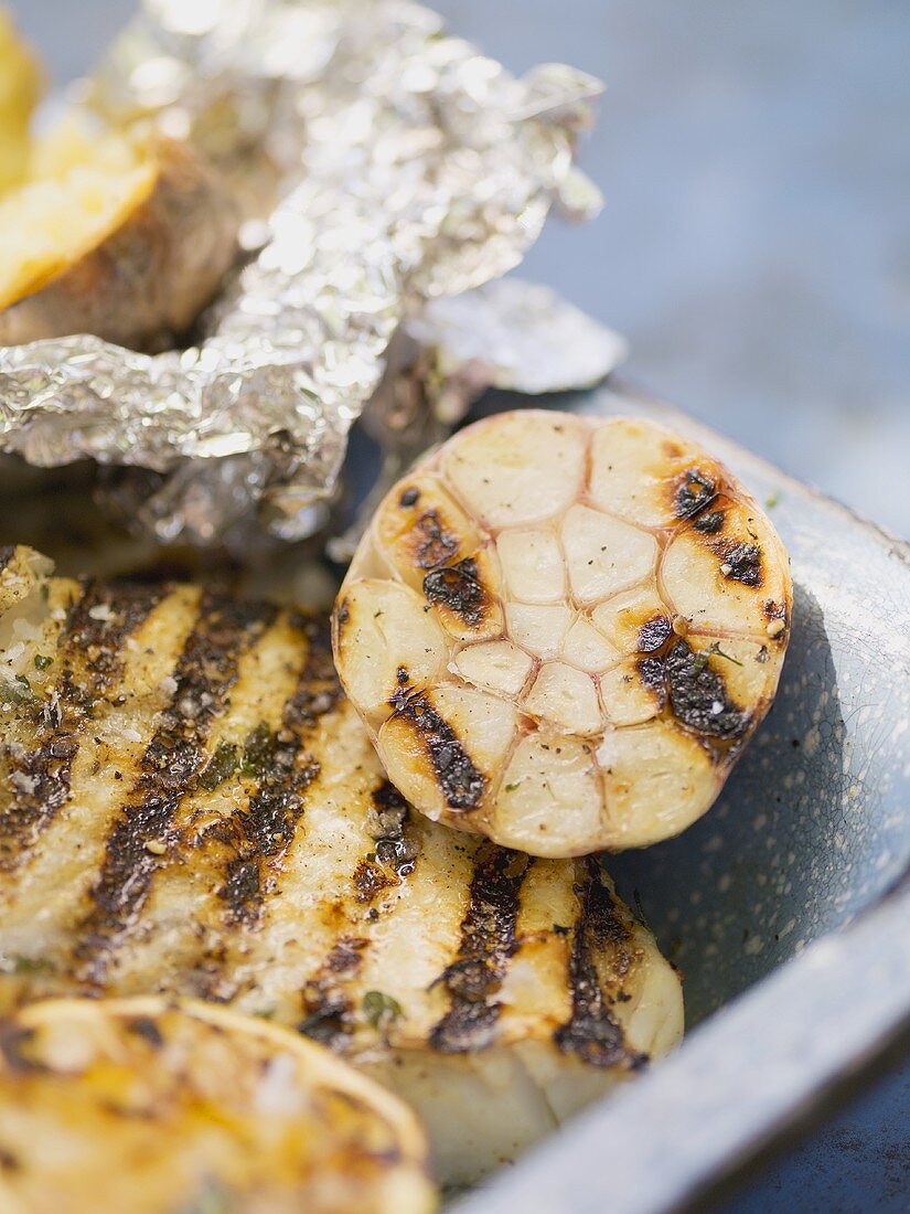Grilled fish fillet with garlic and baked potato