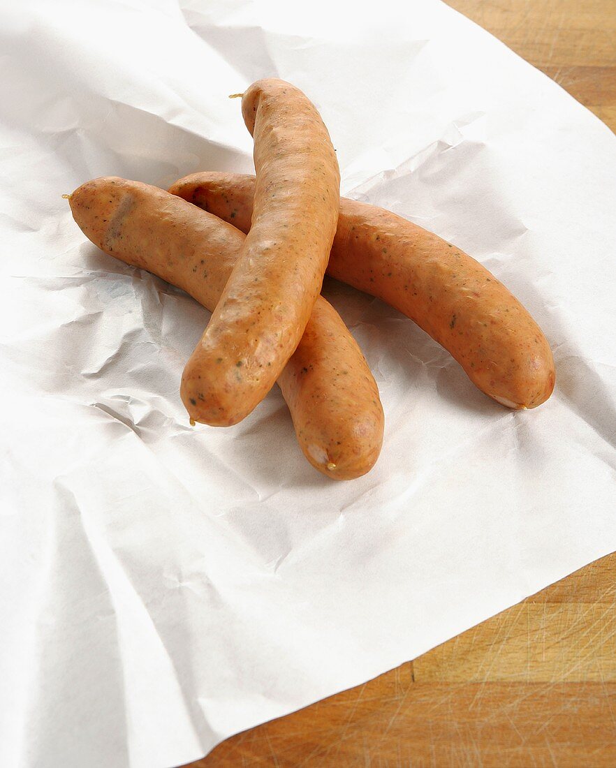 Three cheese-stuffed sausages on paper