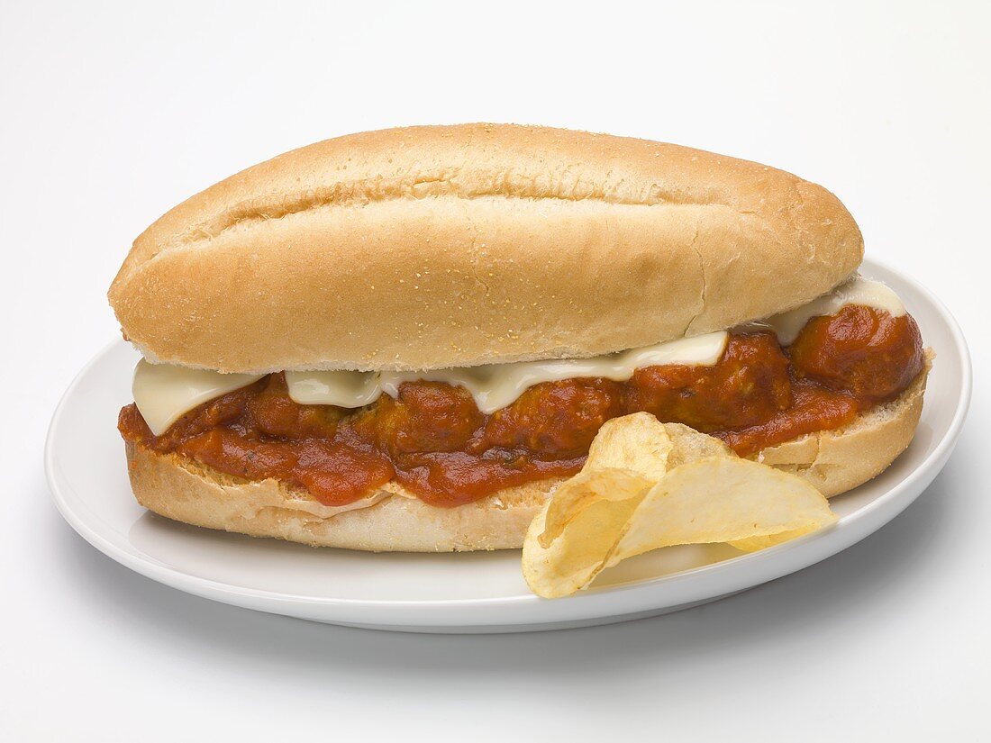Meatball sub sandwich with tomato sauce and cheese, crisps