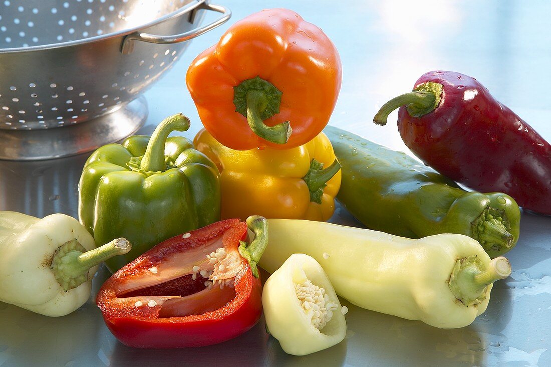 Assorted peppers beside colander