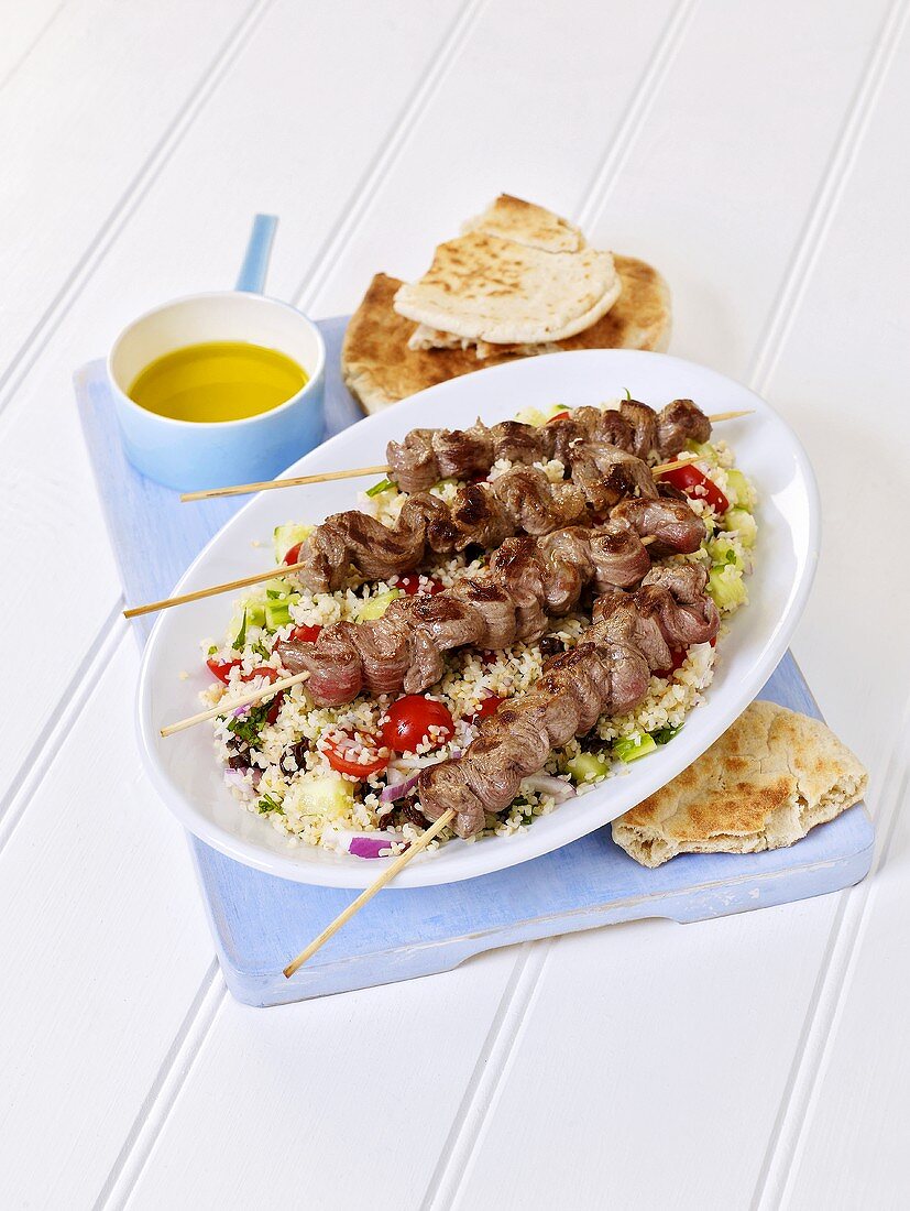 Grilled beef kebabs on couscous