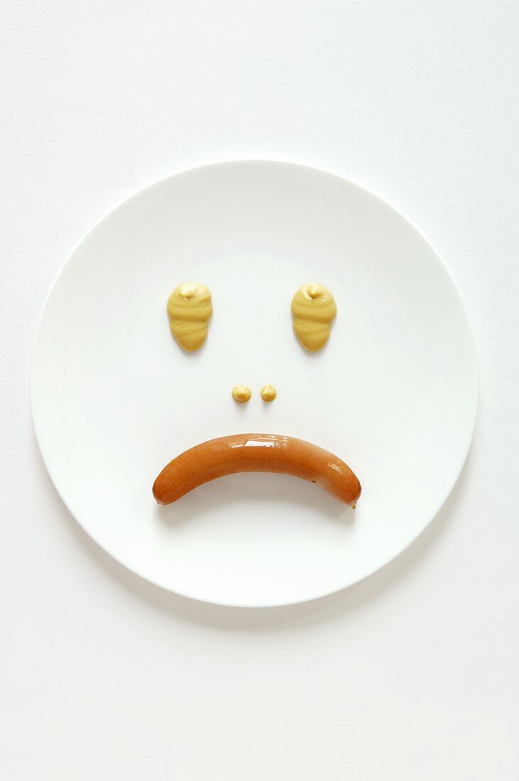 Frankfurter and mustard making a sad face