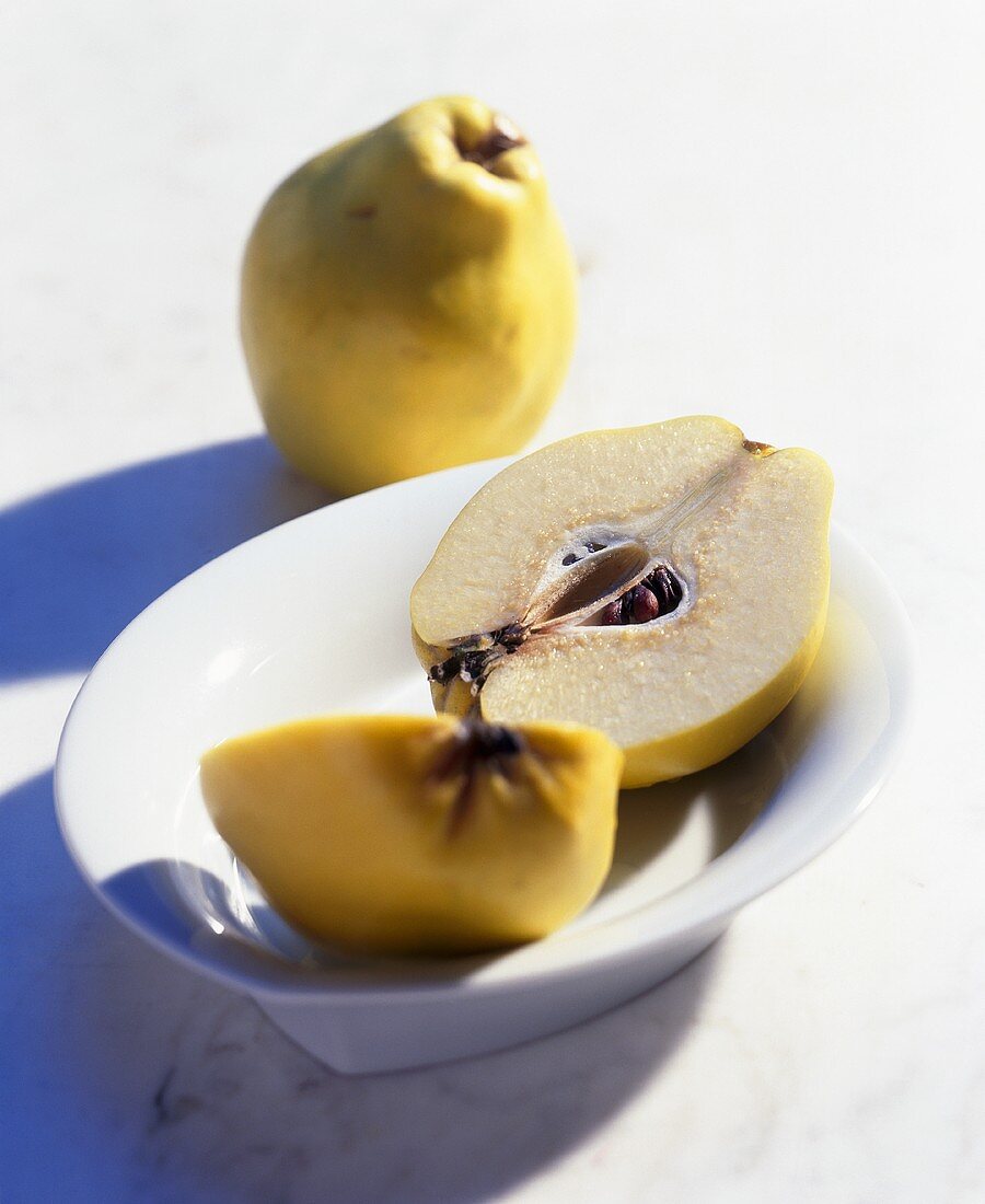 Whole and halved quince