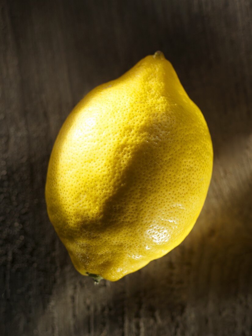 A lemon on wooden background