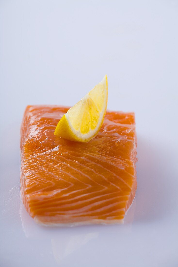 Salmon fillet with lemon wedge