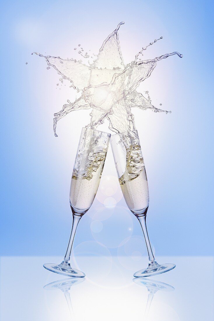 Clinking glasses of sparkling wine (with star-shaped splash)