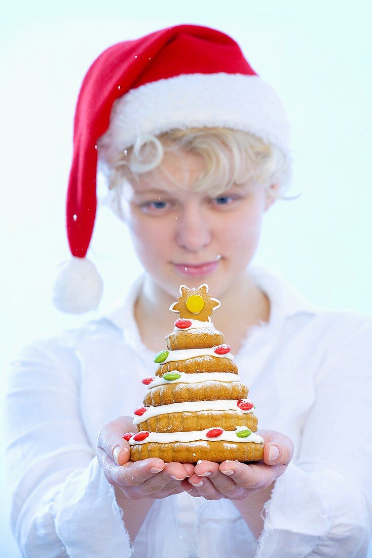 Girl holding biscuit Christmas tree