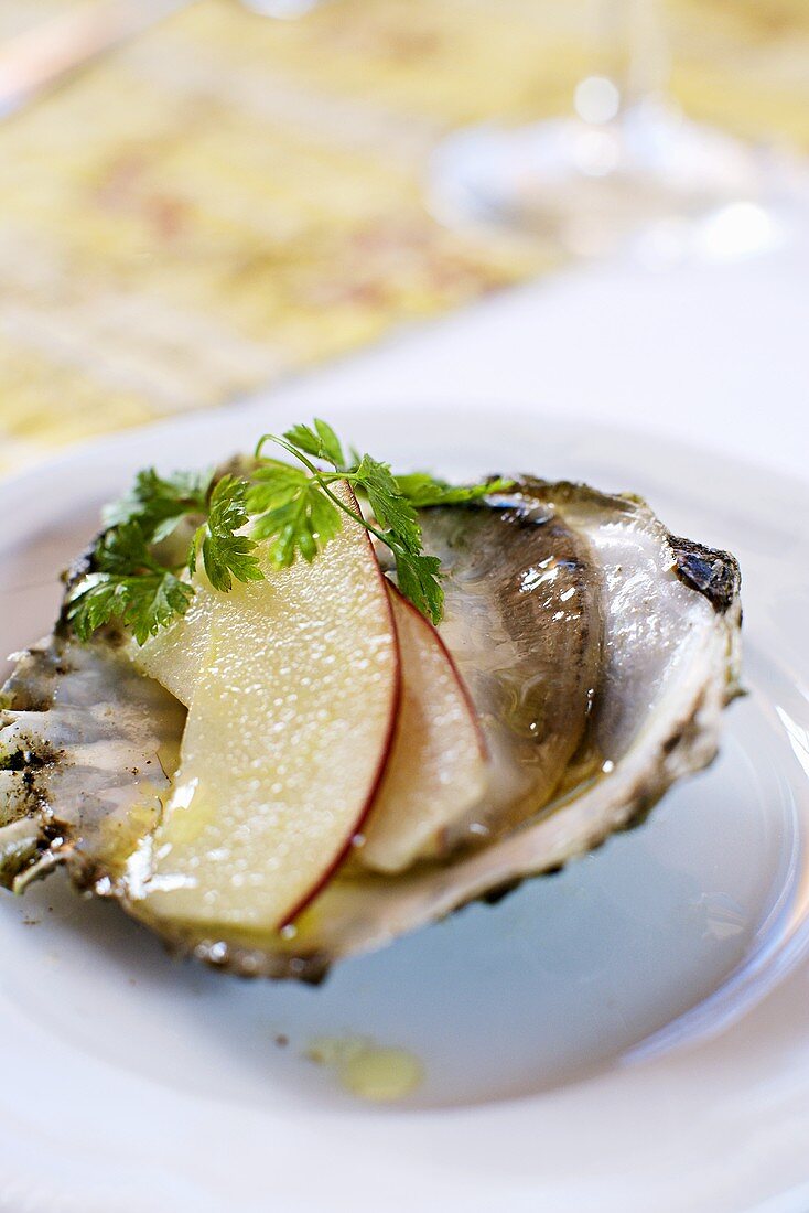 Oyster with slices of apple