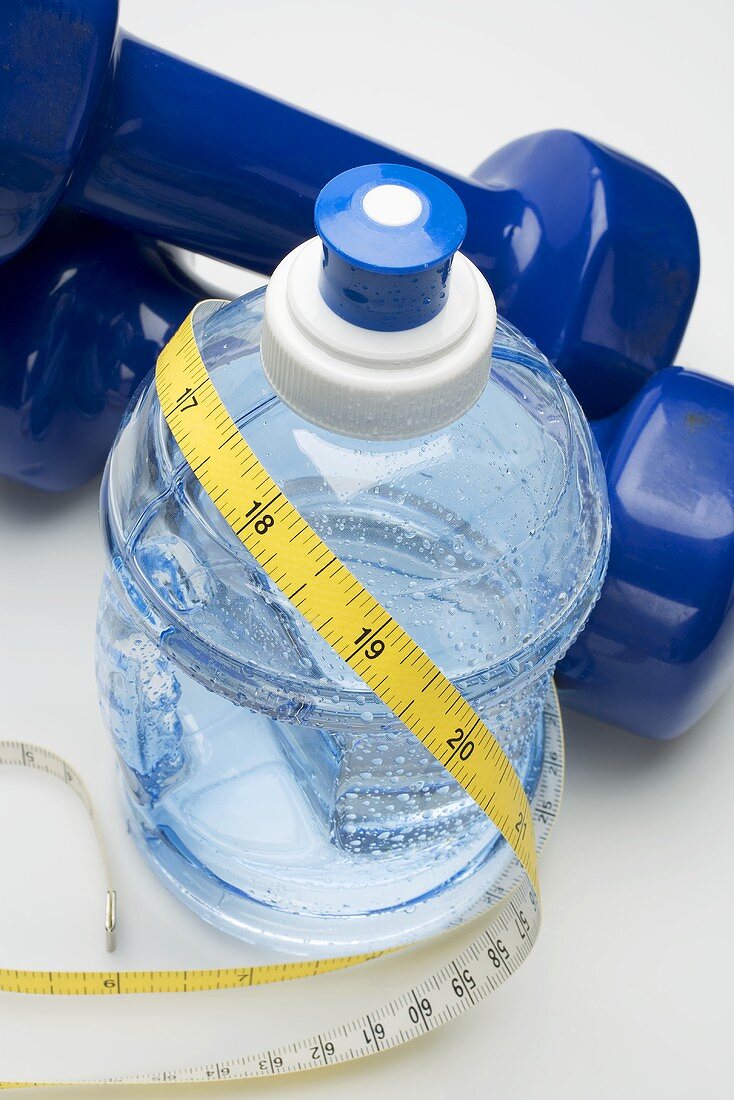 Bottle of water, hand weights and tape measure