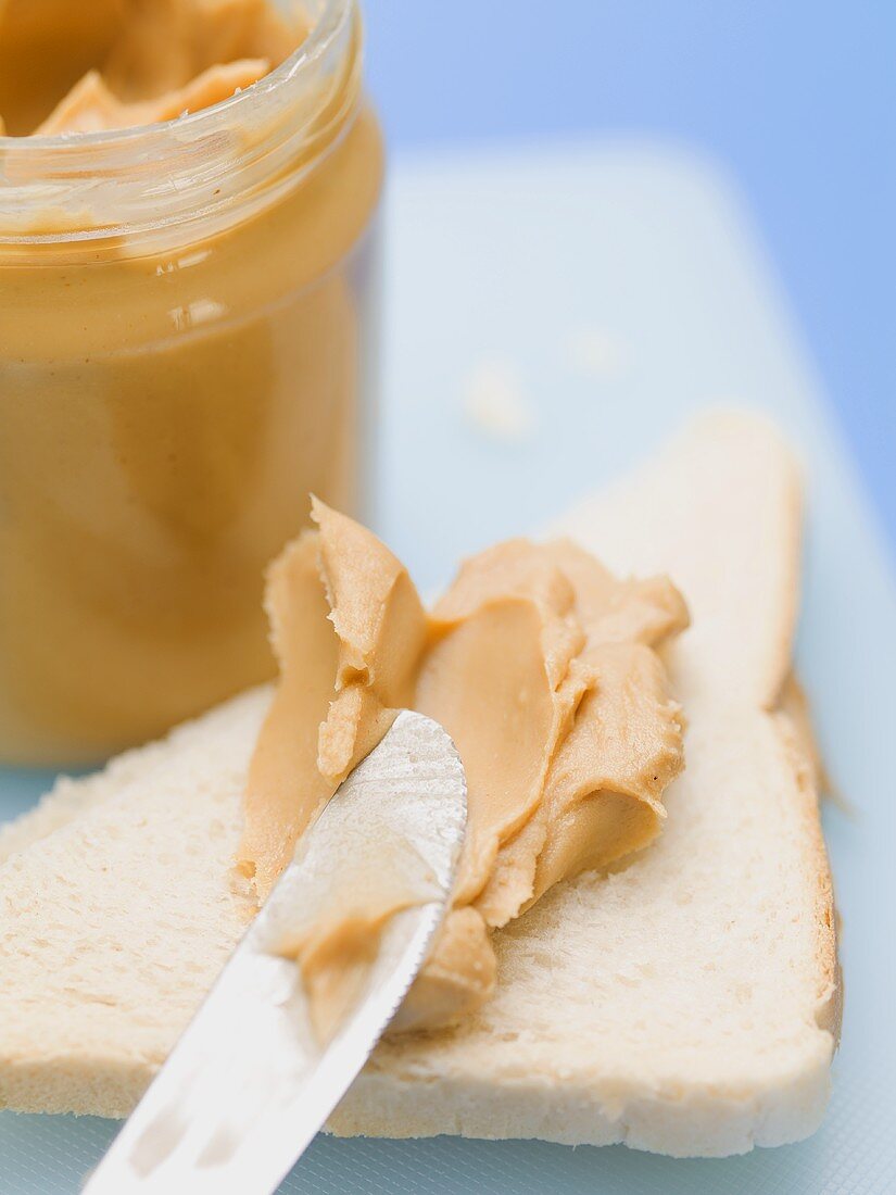 Peanut butter on white bread and in jar