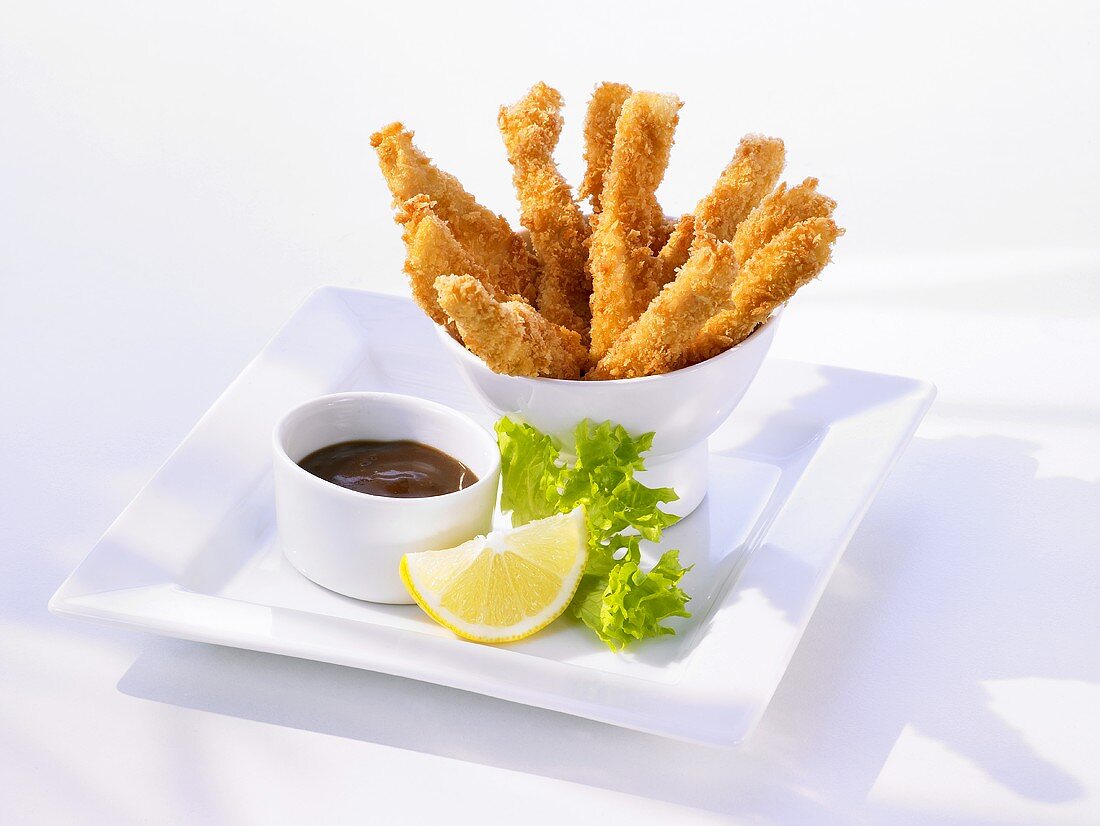 Breaded, deep-fried chicken strips with dip