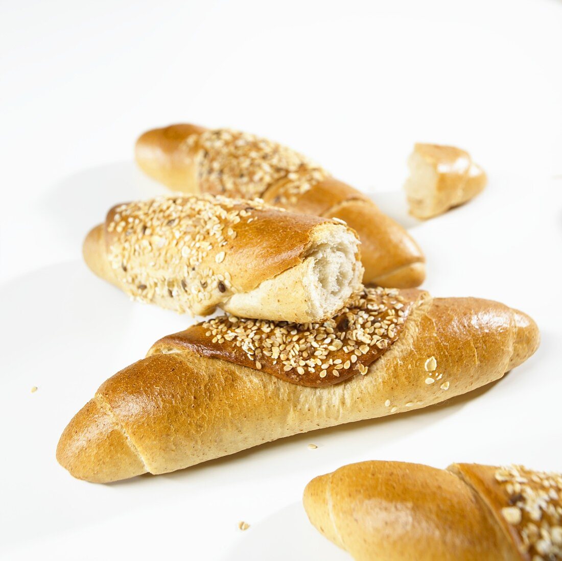 Several grain baguettes, whole and broken