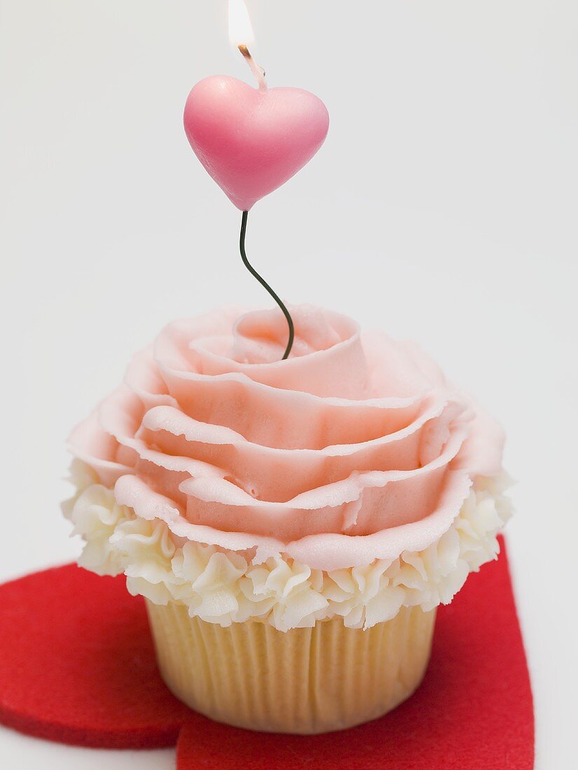 Cupcake with marzipan rose and candle