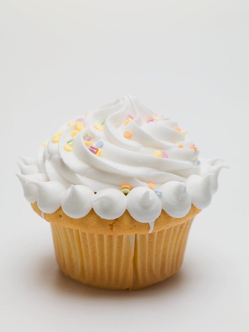 Cupcake with cream and sugar confetti