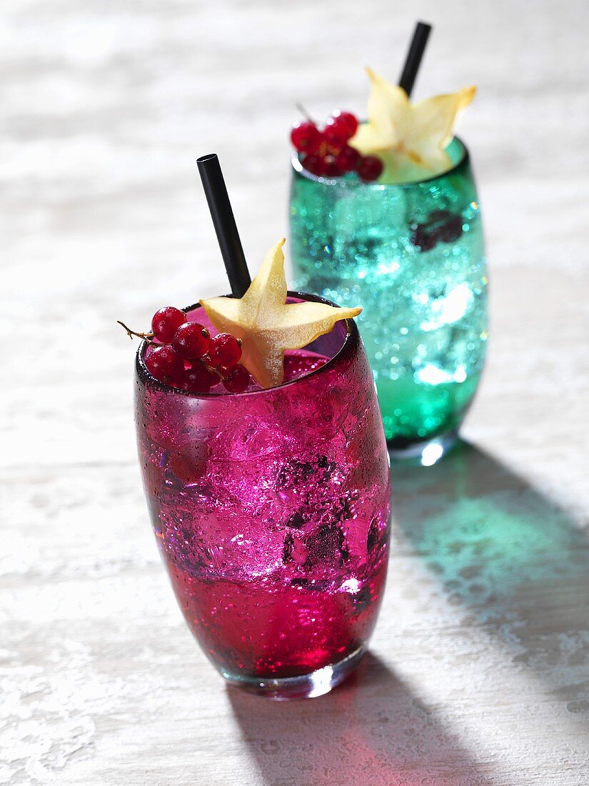 Two cocktails with redcurrants and star fruit