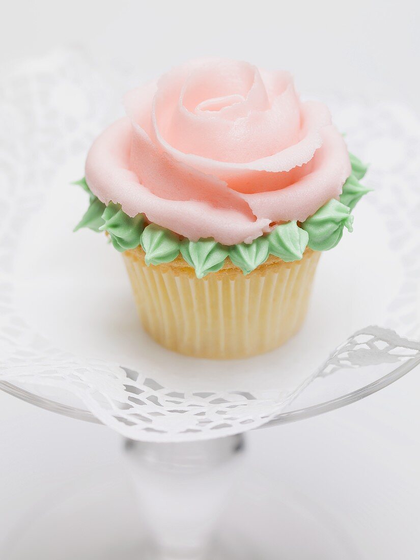 Rose muffin on glass cake stand