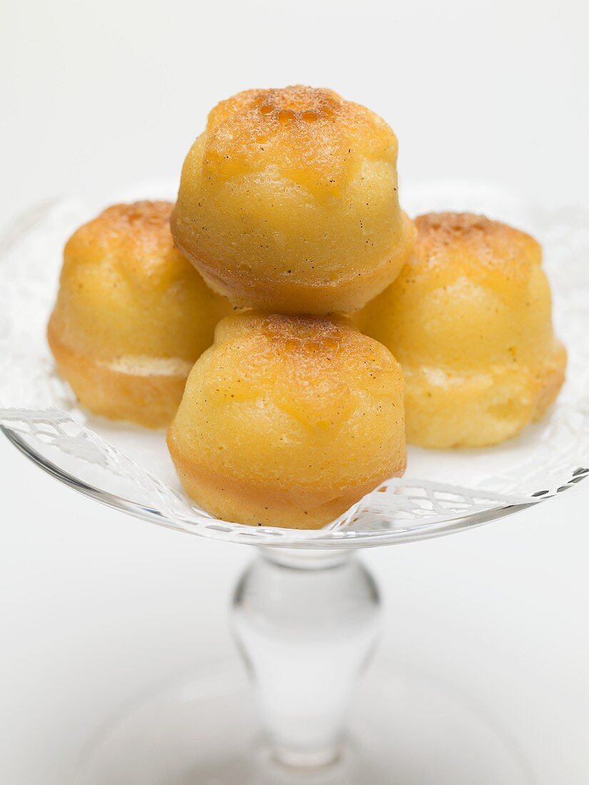 Rum babas on glass cake stand