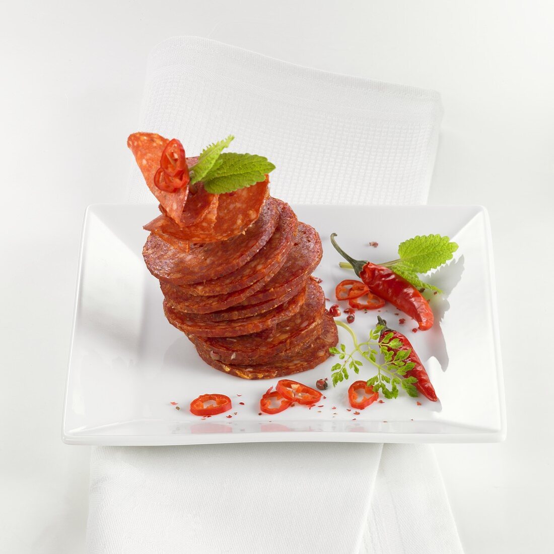 Tower of salami slices with chilli rings
