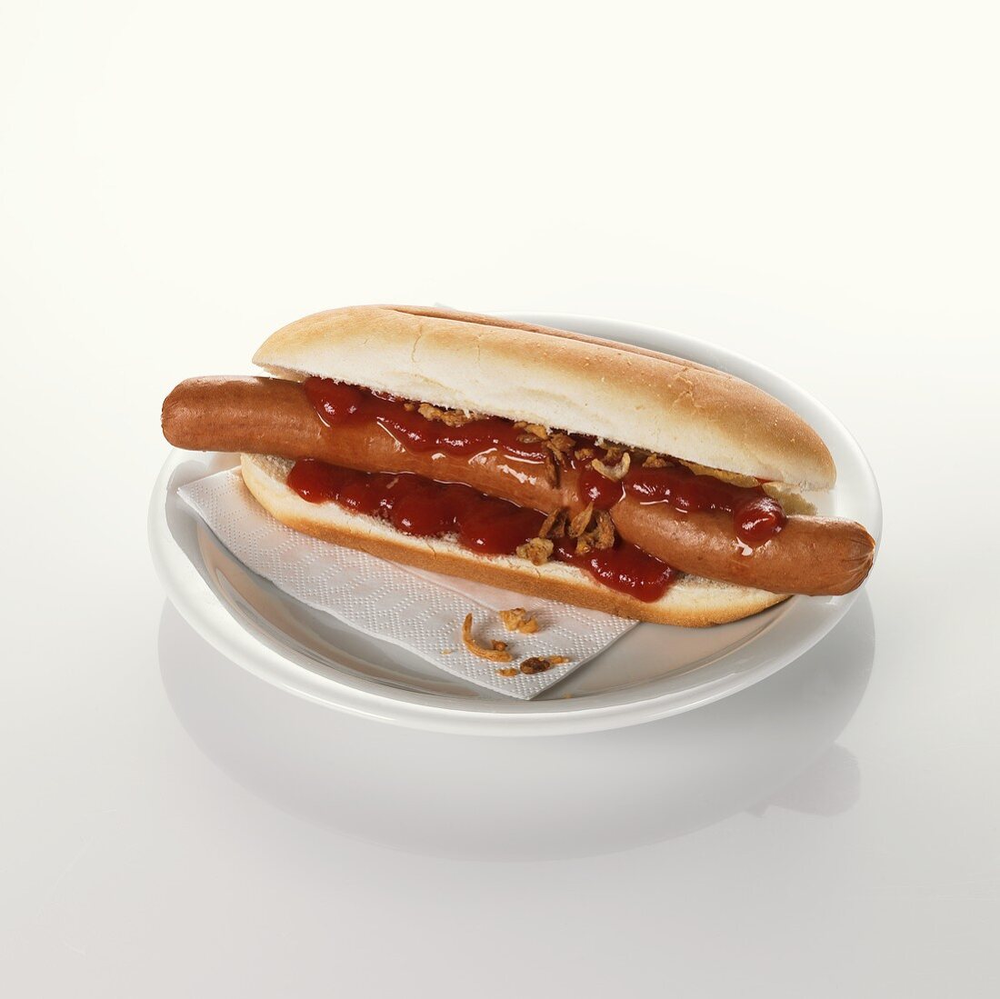 Hot dog with ketchup on plate