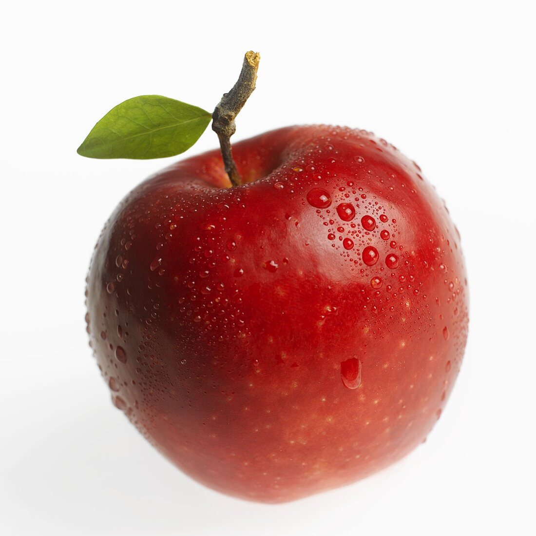 Red apple (Jonagold) with leaf and drops of water