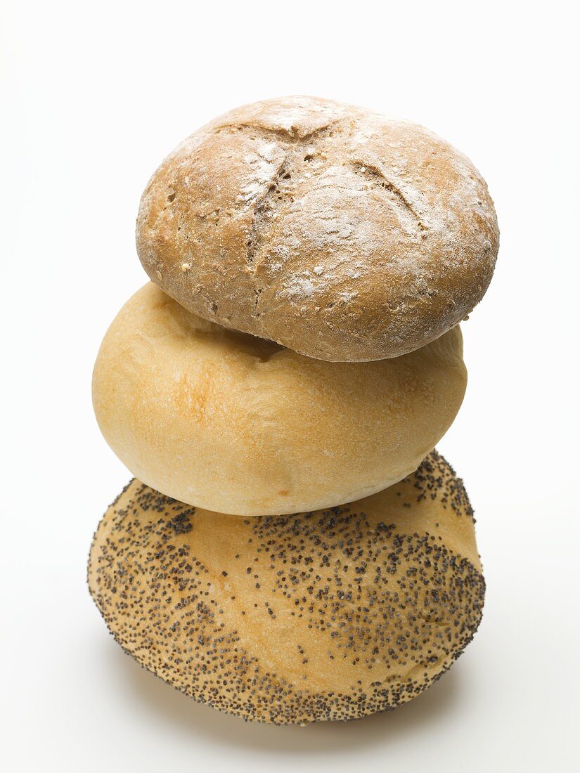 A poppy seed roll, a kaiser roll and a rye roll