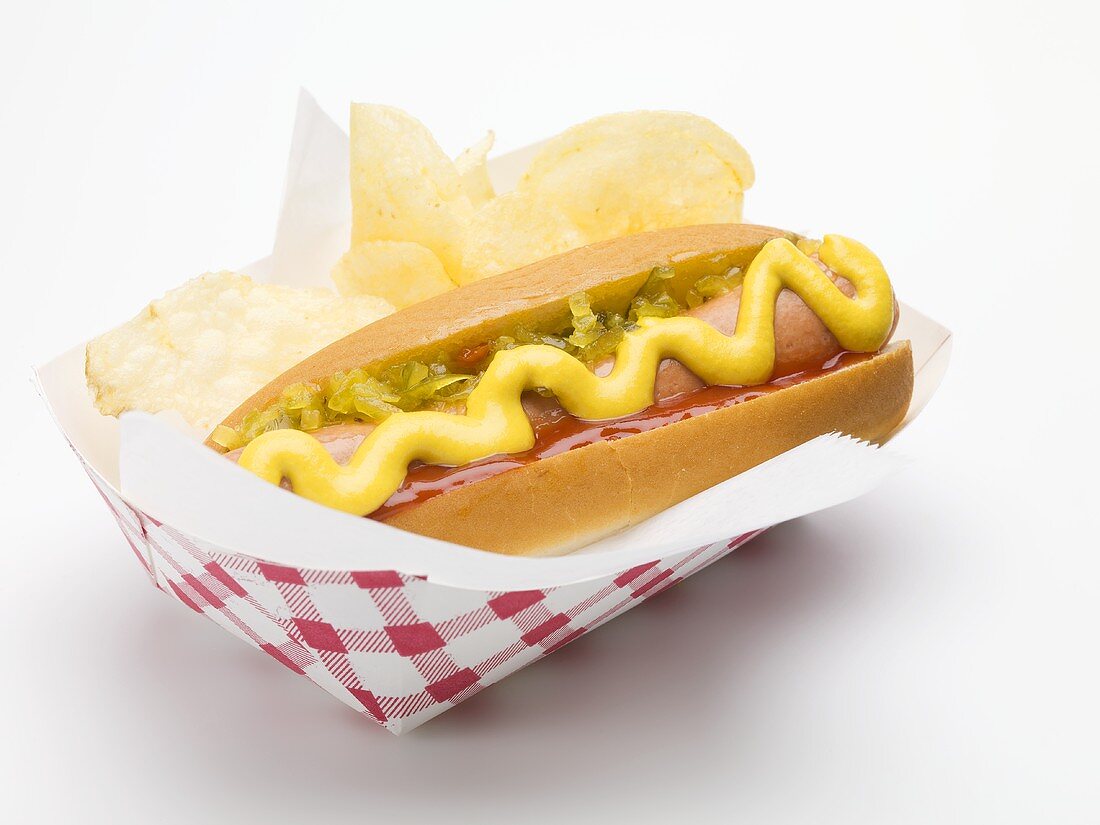 A hot dog with potato crisps