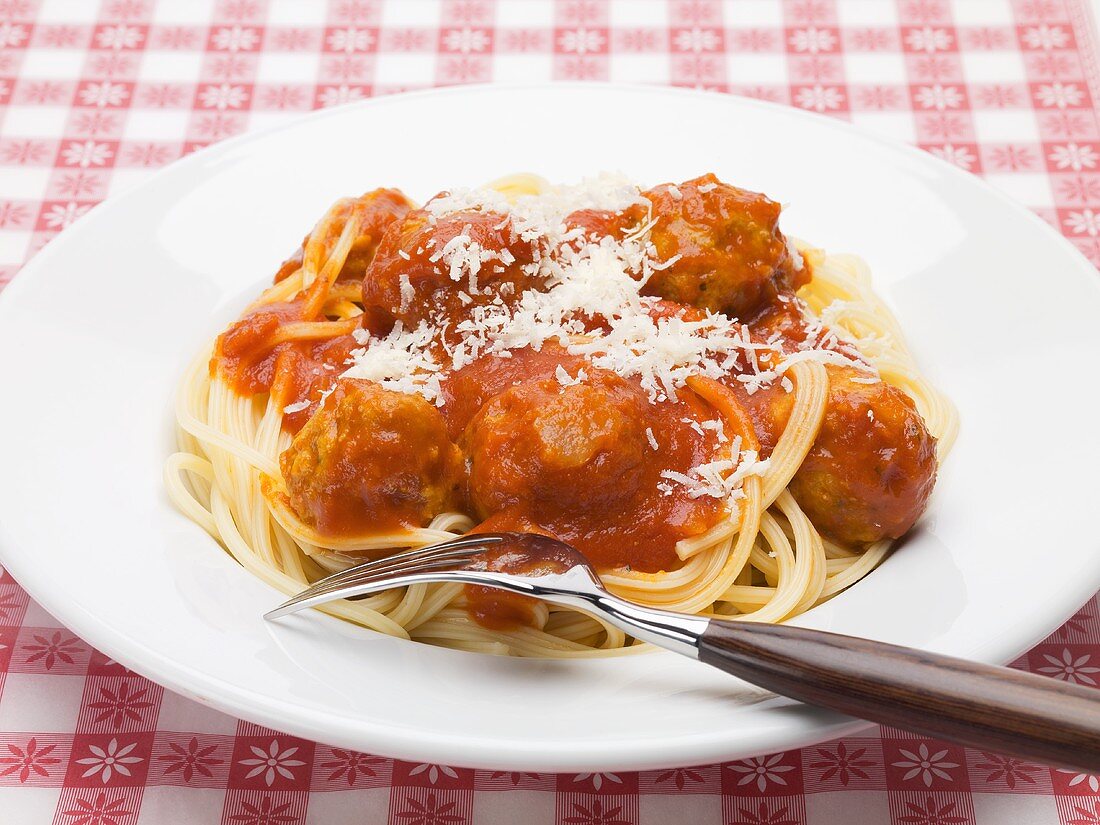 Spaghetti with meatballs in tomato sauce and Parmesan