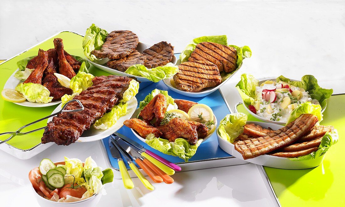 Various grilled dishes with salads