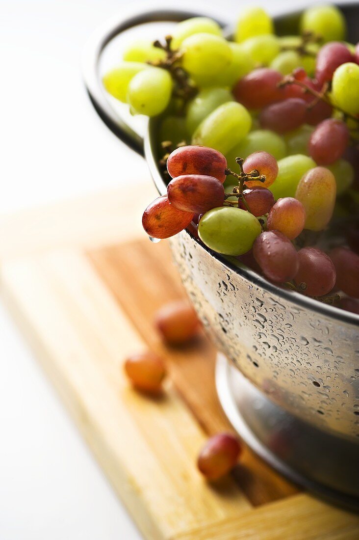 Fresh Red and Green Grapes in a Colander