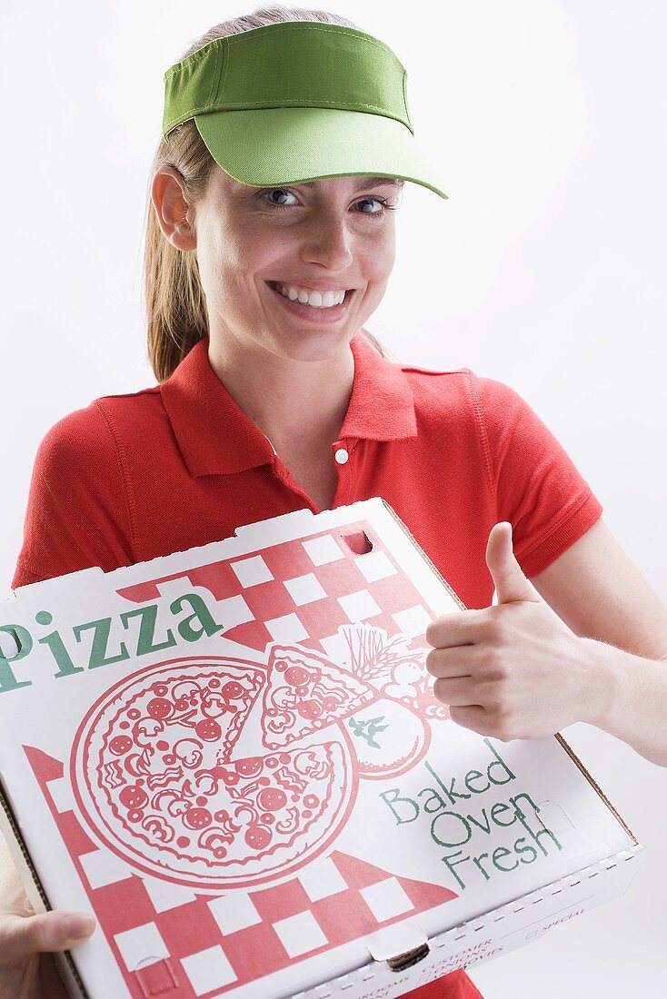 Smiling woman with pizza box, giving thumbs up sign