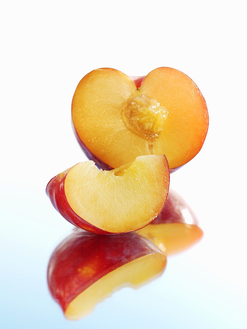 Half a plum and wedge of plum with reflection