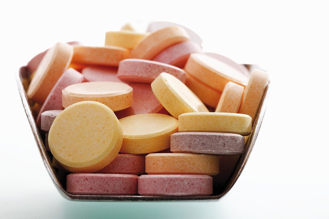 Coloured glucose tablets in scoop